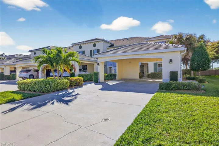 Mediterranean / spanish home with stucco siding, a front lawn, concrete driveway, and a tile roof