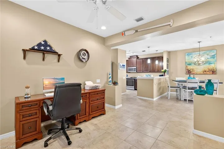 Office space with a chandelier, a ceiling fan, light tile patterned floors, and recessed lighting