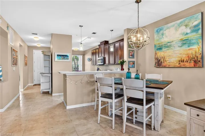 Dining space with baseboards and a chandelier