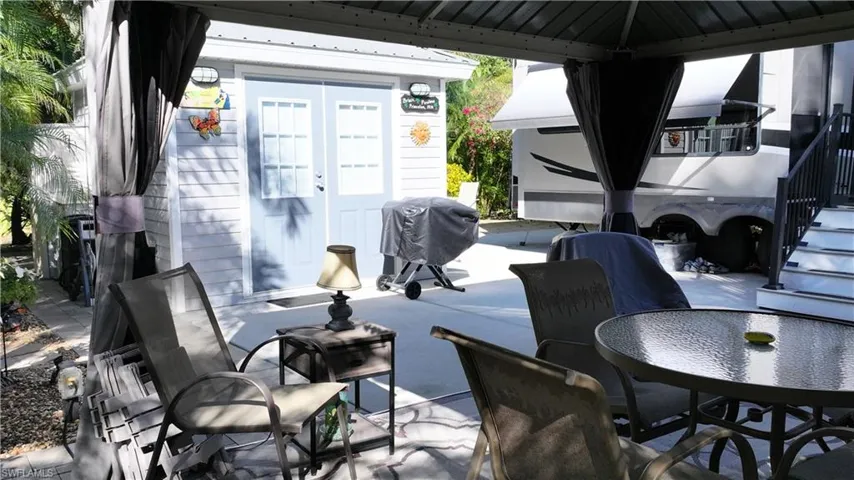 View of patio with grilling area, french doors, and outdoor dining area