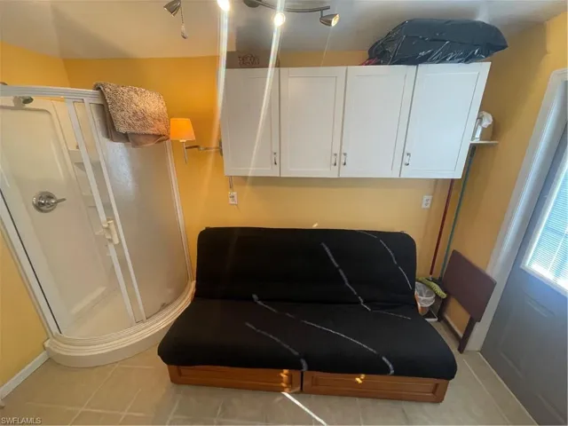 Sitting room featuring light tile patterned flooring and baseboards