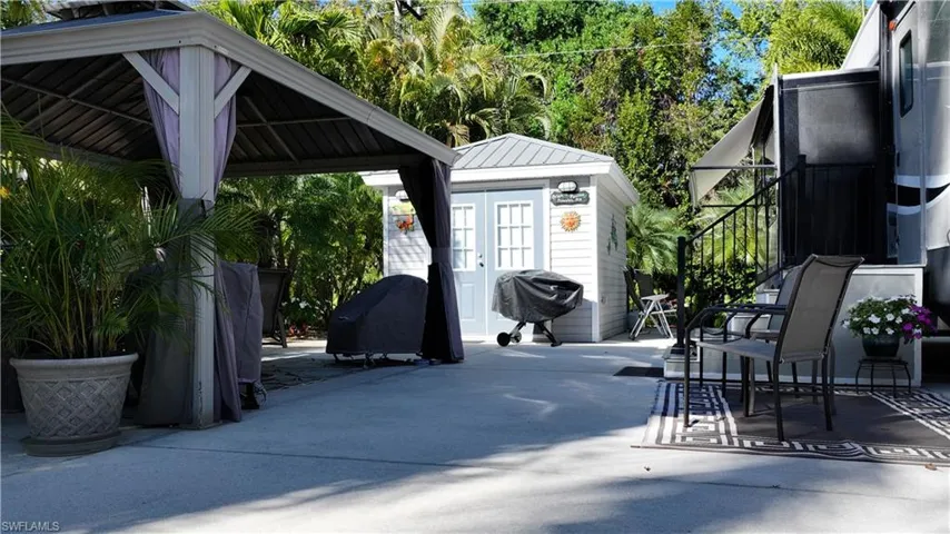 View of patio / terrace featuring an outbuilding and a grill