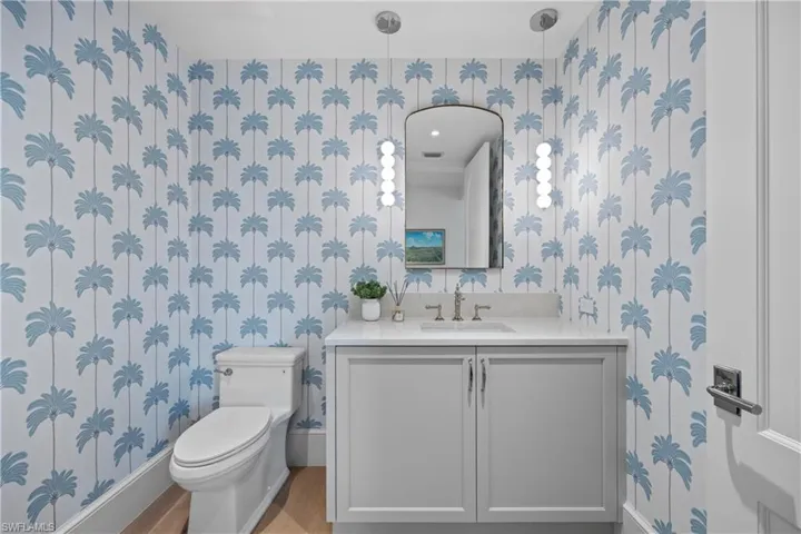 Bathroom with toilet, hardwood / wood-style flooring, and vanity