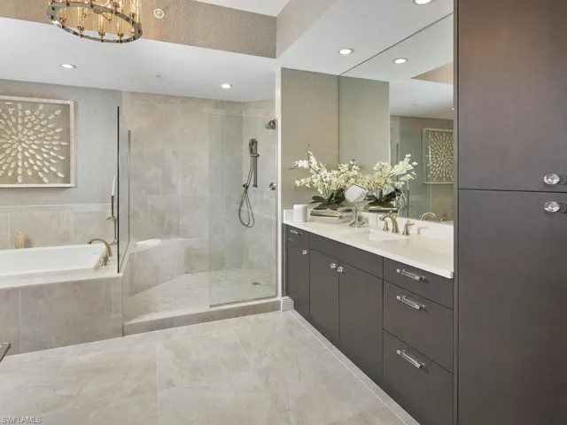 Bathroom featuring vanity and shower with separate bathtub