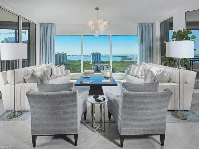 Living room with a notable chandelier and a water view