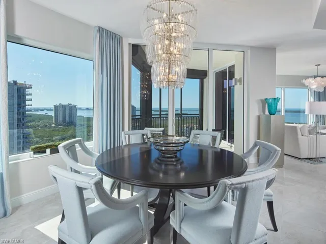 Dining area with a water view and a notable chandelier