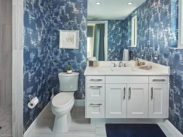Bathroom with hardwood / wood-style flooring, vanity, and toilet