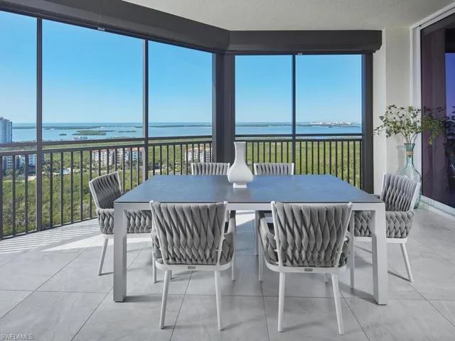 Sunroom / solarium with plenty of natural light and a water view