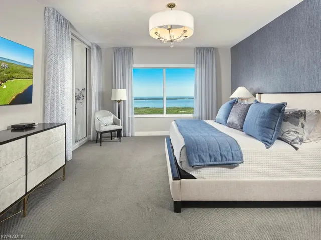Bedroom with carpet and a water view