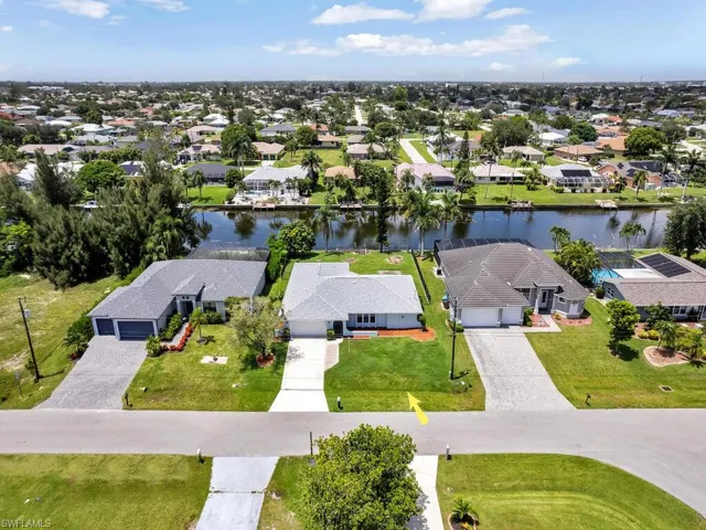 Aerial view of home on Fresh water canal, and surrounding neighborhood.