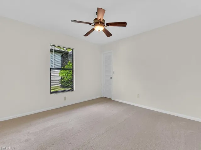 Full bath with vanity, shower / washtub combination, tile patterned floors, and ceiling fan