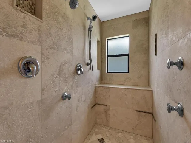 View of spacious family room, with laundry room entrance and bedrooms entrance in the background. Taken from the foyer hallway.