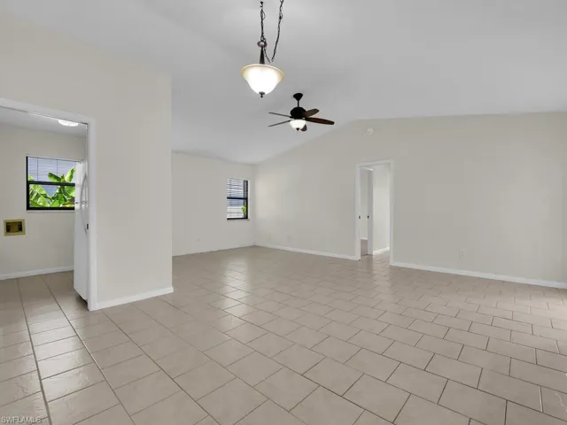 view standing in the foyer looking through the dining room to Patio slider and Master bedroom door.