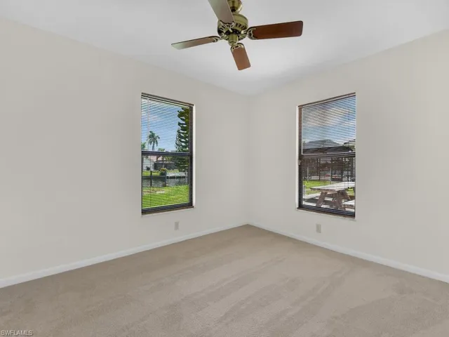 View of family room with front door, laundry entrance, and windows%