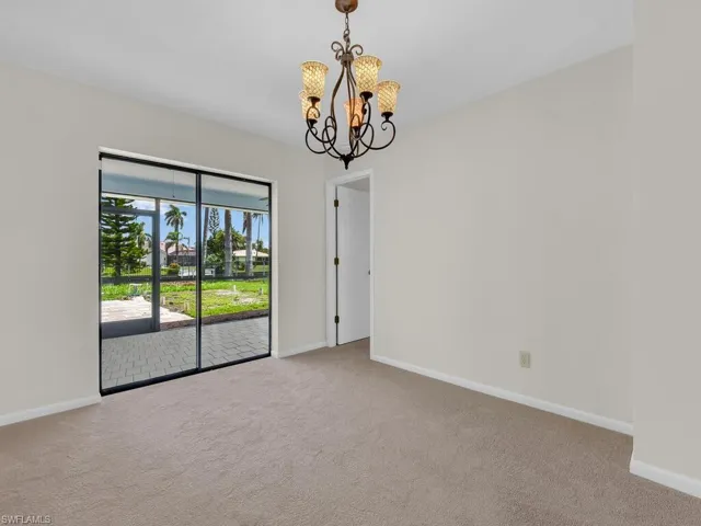 Family room area  connected to the kitchen with a ceiling fan, and ceramic tile. Virtual staging imposed.