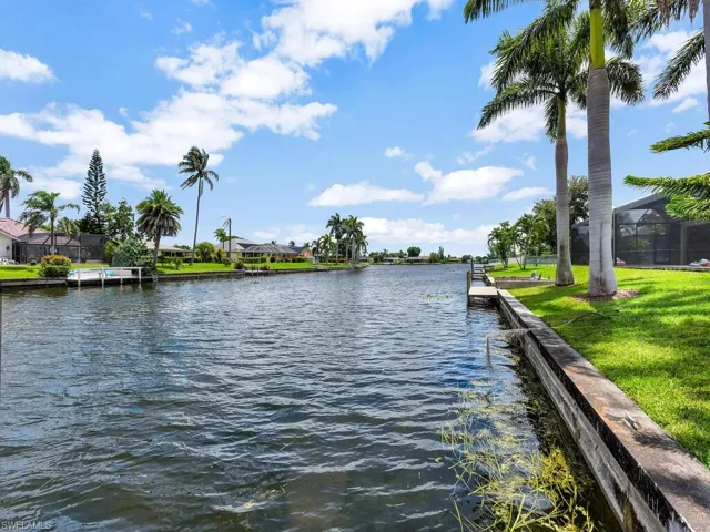 Dock area featuring a water view, a yard, and a residential view