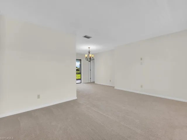 View of Master bedroom with bathroom in the background. Taken from the entrance door. Virtual staging imposed.