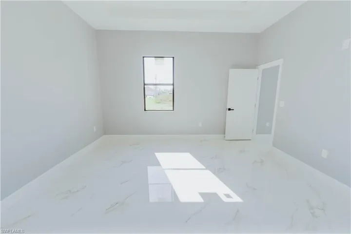 Spare room with a raised ceiling