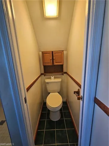 Bathroom featuring tile patterned flooring and toilet