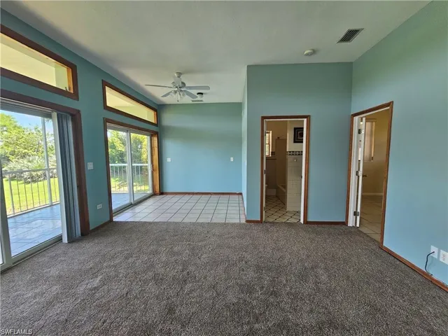 Carpeted spare room with ceiling fan
