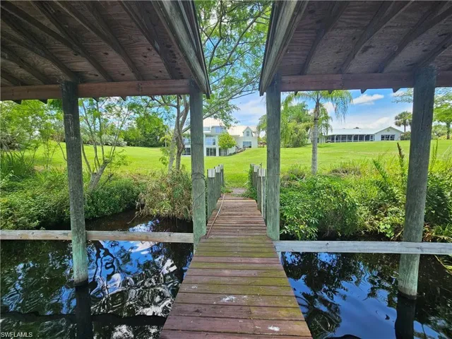 View of dock featuring a lawn