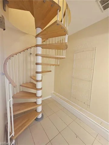Staircase featuring tile patterned floors