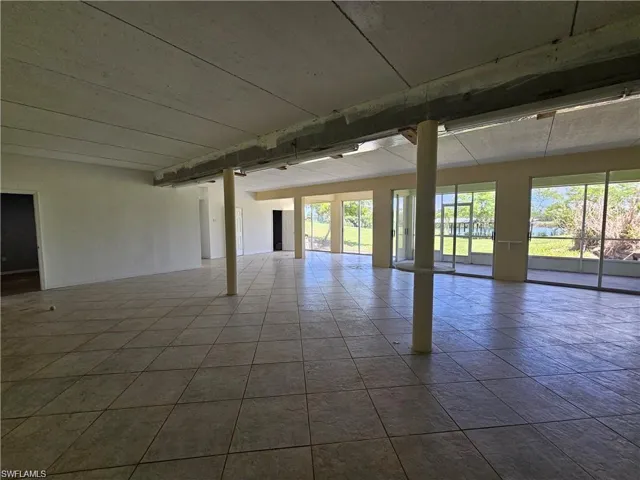 Tiled spare room with a healthy amount of sunlight