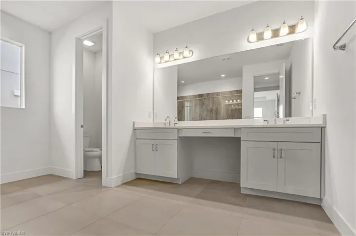 Primary bathroom with dual-sinks and quartz countertops