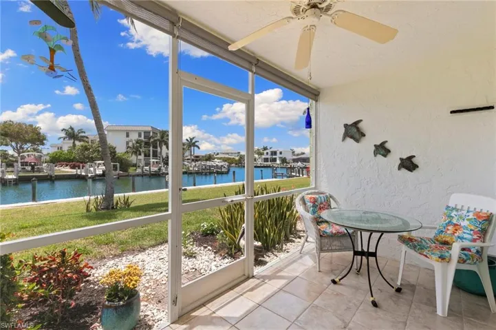 Tiled, screened lanai with sun shades for added comfort