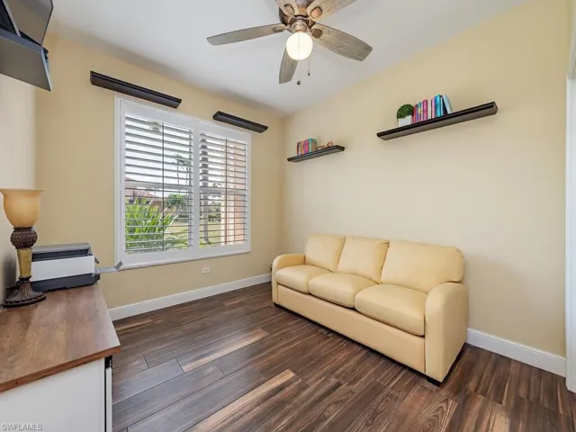 Guest bedroom features large closet, tile floors, windows with plantation shutters creating an open airy feel.  This room can also be used as an office/den area.