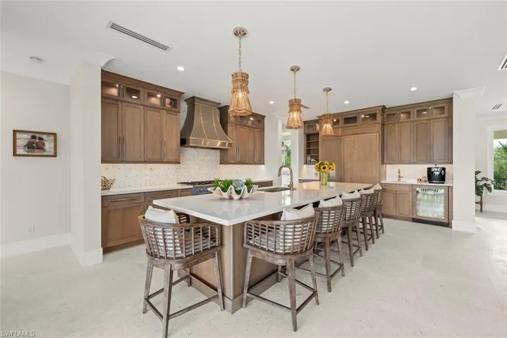 Chef’s kitchen with custom cabinetry, large island, and modern design.