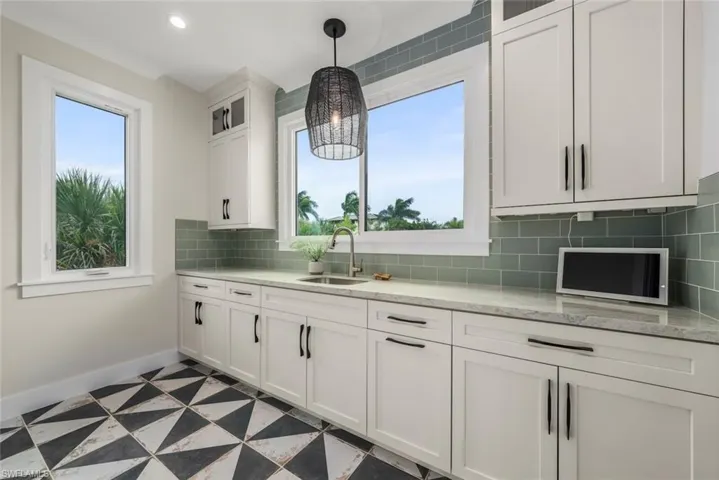 Additional space featuring ample cabinetry and counters.