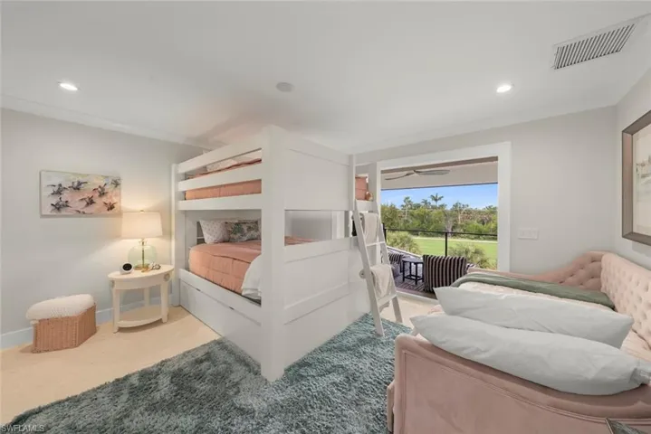 Functional multi-bed room designed for kids or guests, offering both bunk and pull-out beds.