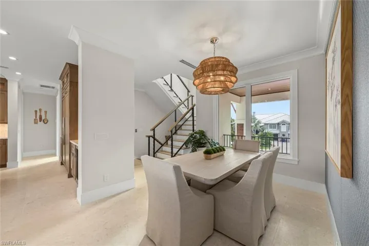 Upper landing with den seating area, high ceilings and large windows.
