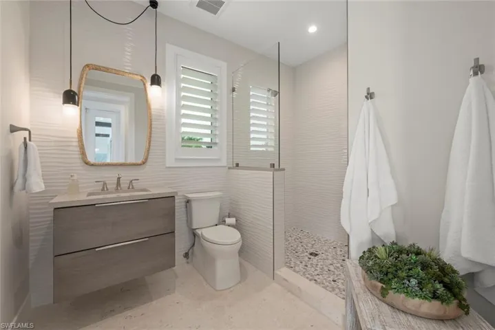 Guest bathroom with walk-in shower and classic finishes.