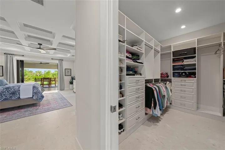 Custom walk-in closet with built-in shelving and ample storage.
