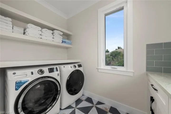 Laundry room with front-loading washer and dryer.