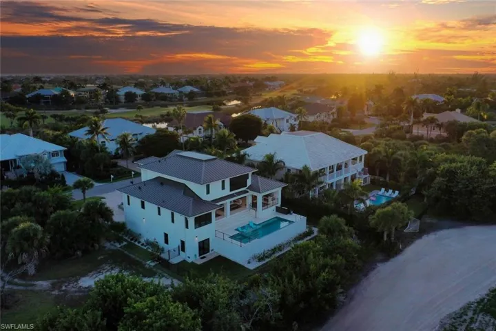Sunset aerial view showcasing the home at golden hour.