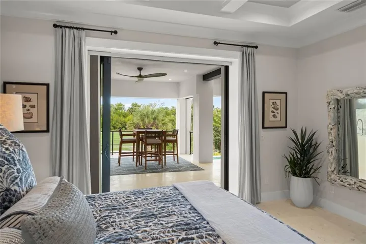Spacious primary bedroom featuring sliding doors to the balcony.