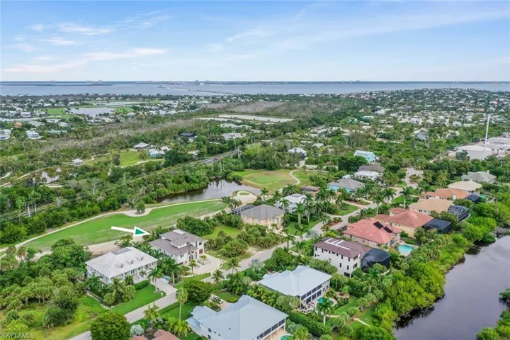 Aerial perspective showcasing nearby homes and landscape.