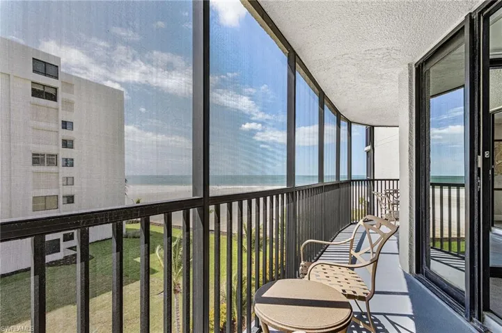 Screened balcony with metal railings and direct ocean scenery