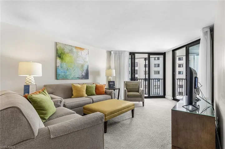 White walls and light-colored carpeting enhance the bright ambiance