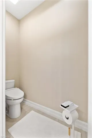 Bathroom featuring baseboards and light wood finished floors