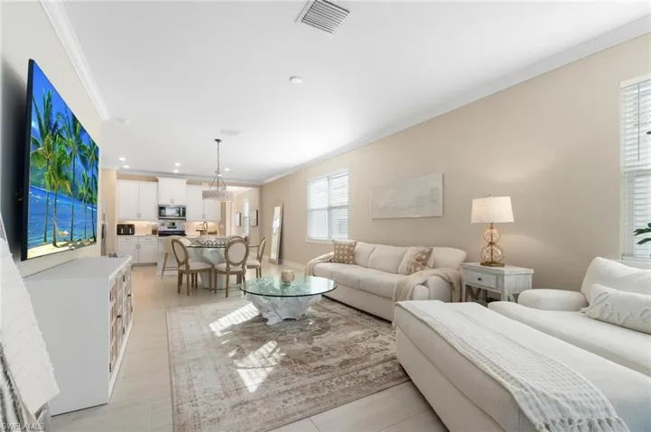 Living room featuring crown molding and recessed lighting