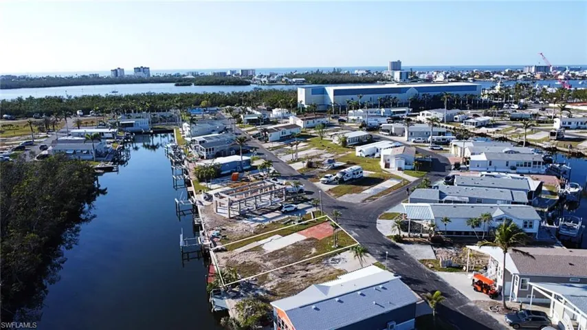 Birds eye view of property with a water view