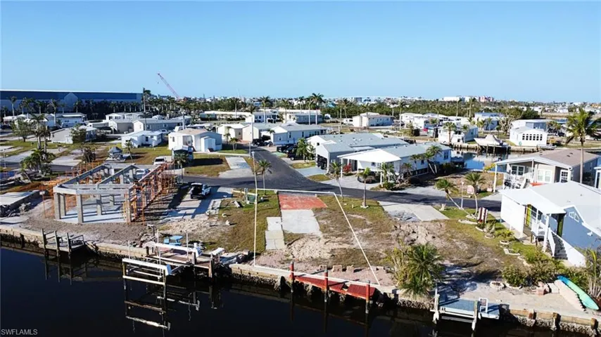 Birds eye view of property with a water view