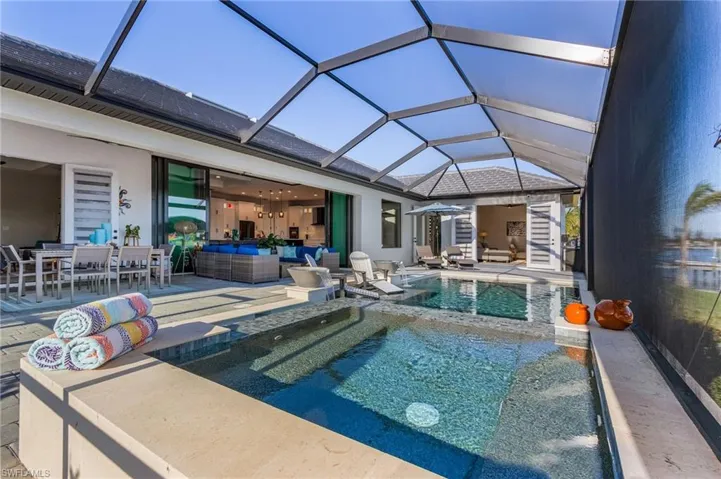 View of pool with a lanai, an outdoor hangout area, and a patio