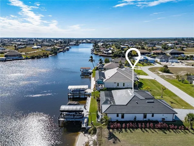 Birds eye view of property with a water view