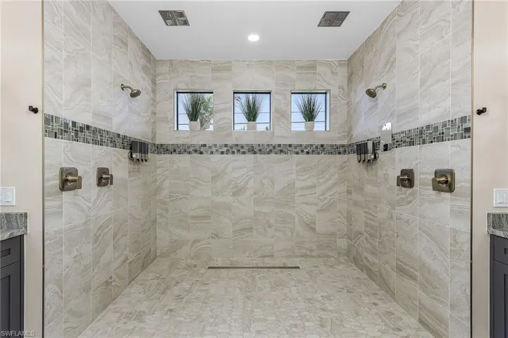 Bathroom with vanity and a tile shower