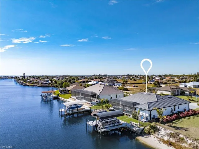 Birds eye view of property with a water view